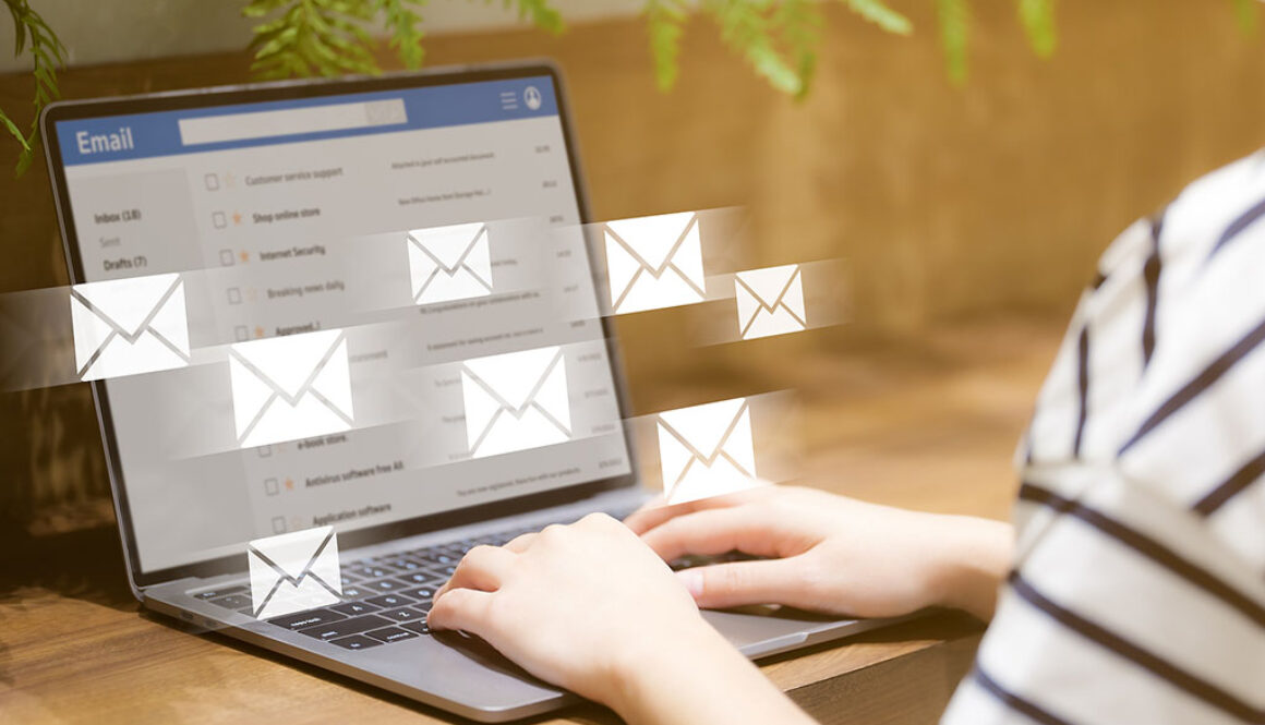 Closeup of a Woman Looking At Her Email Inbox With Email Icons Flying From Her Laptop Screen Why Is Email Marketing Effective
