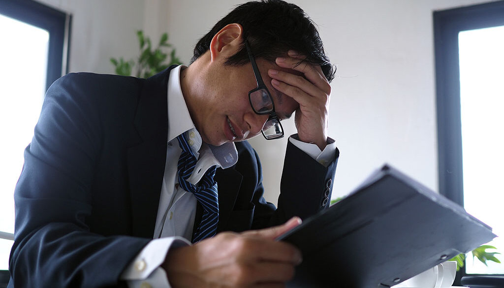 Closeup Of A Stressed Business Owner Looking At A Tablet Holding His Head Financial Contingency Funds In Business