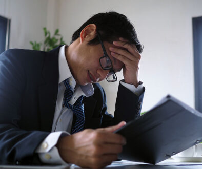 Closeup Of A Stressed Business Owner Looking At A Tablet Holding His Head Financial Contingency Funds In Business