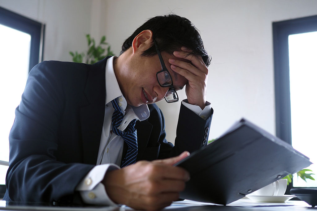 Closeup Of A Stressed Business Owner Looking At A Tablet Holding His Head Financial Contingency Funds In Business